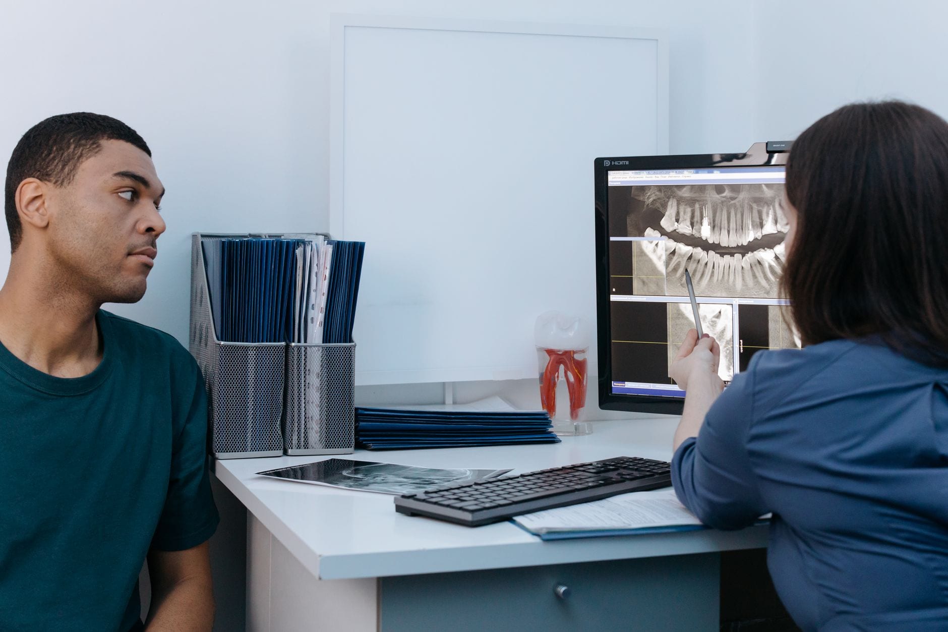 A dentist walking a patient through their x-ray