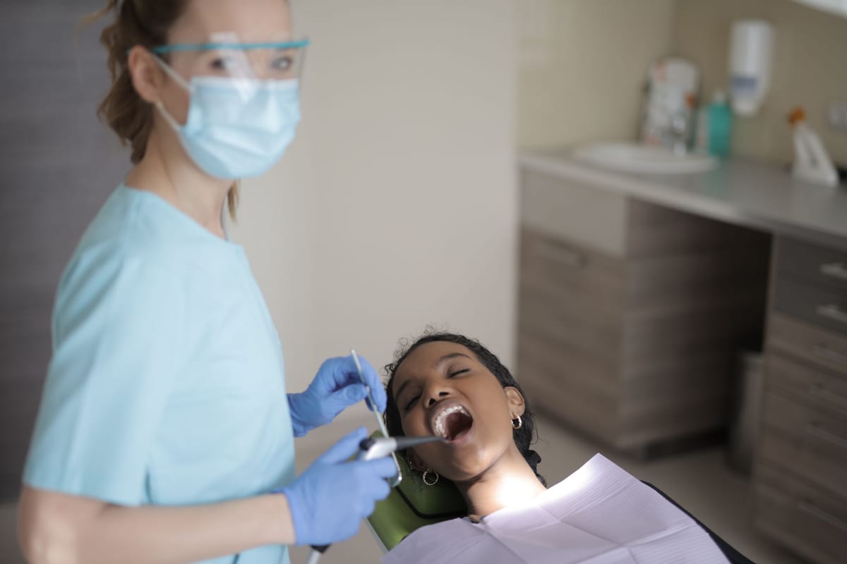 A hygienist mid-cleaning